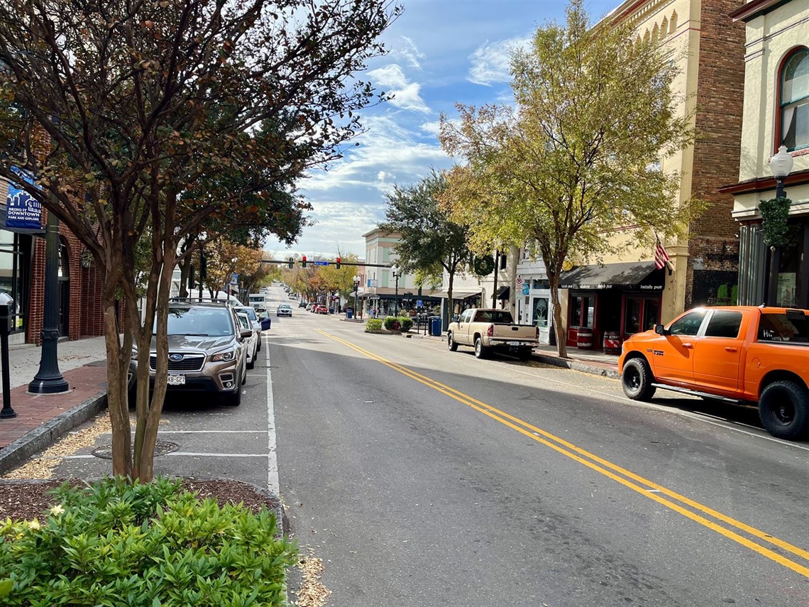 Cars are parked along Front Street during the fall season.