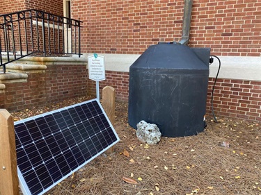 Cistern with solar pump by building
