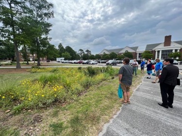 Attendees observe a rain garden planted at UNCW.