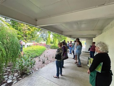 Workshop attendees observe a rain garden at the NHC Arboretum.