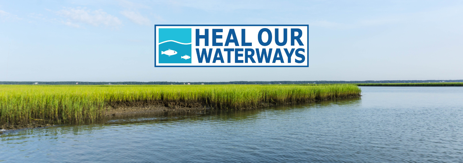 Heal Our Waterways logo over creek. 