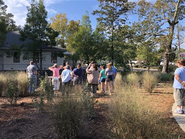 Attendees look at the infiltration basin at the NHC Arboretum